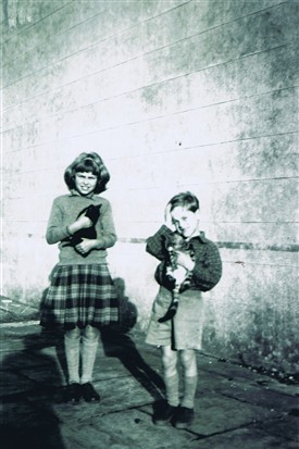 Photo:Bernadette and brother Peter with kittens at the back of the mansion around 1953